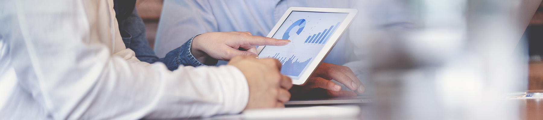 People lookng at charts and reports on a tablet